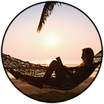 Person reading in hammock at sunset